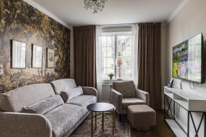 a living room with a couch and two chairs at Söderfors Herrgård in Söderfors