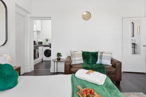 a living room with two beds and a couch at Nile - Cosy Studio Apartment by Traboule Properties Ltd in Warrington