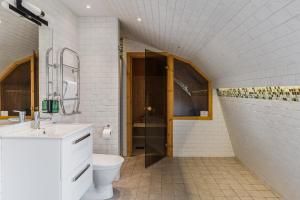 a white bathroom with a toilet and a sink at Söderfors Herrgård in Söderfors +66 photos