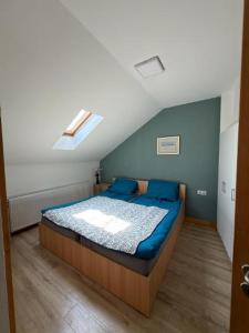 a bedroom with a bed with blue pillows at Cazare Turnisor in Sibiu