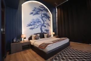 a bedroom with a bed with a blue and white wall at L'Elegant Resort in Chail