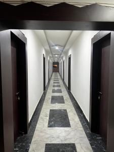 a hallway with doors and a tile floor in a building at Seasons Resorts in Jabalpur
