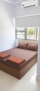 a bed in a room with two pillows on it at Seasons Resorts in Jabalpur