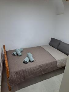 a bed with two pillows on it in a bedroom at Patasa holiday apartment in Pyrgi