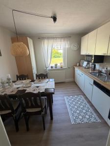 a kitchen with a table and chairs and a kitchen with a sink at Bella's Eden in Grimma