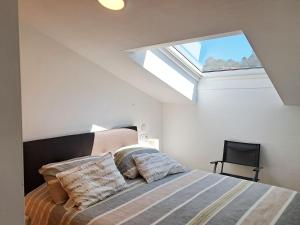 a bedroom with a bed with a skylight at Bella Vista in Portosin