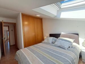 a bedroom with a bed with pillows on it at Bella Vista in Portosin