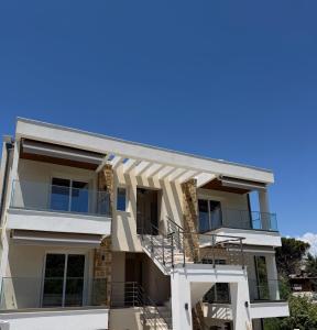 an image of a house with a blue sky at Azulic Suites Nikiti in Nikiti