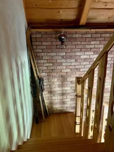 a staircase in a room with a brick wall at Chalupa pri Ukoch s wellness, Bílé Karpaty in Matěk +64 photos