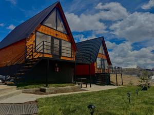 a large red barn with a gambrel roof at Aura Gudauri in Gudauri
