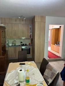 a kitchen with a table and chairs and a kitchen with a table and a kitchen at Holiday House Ostrozac na Uni in Ostrožac +8 photos