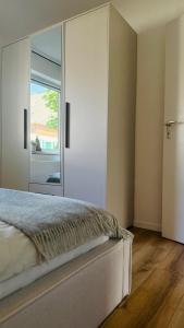 a bedroom with a bed and a large window at Nord Loft in Langeoog