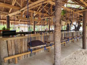 a porch with a hammock in a resort at Pili Beach Resort Agmanic in Santa Fe