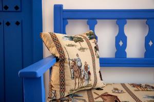 a pillow on the back of a blue chair at Casa Rural La Posada del Quijote in Puerto Lápice +168 photos