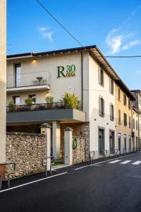 a building with a sign on it on a street at Boutique Hotel Roma 30 in Trescore Balneario
