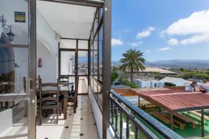 a balcony with a table and chairs and a view at Villa Jomeca in Salobre