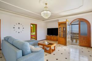 a living room with a blue couch and a tv at Villa Jomeca in Salobre