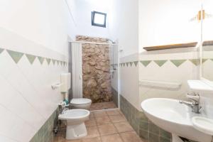 a bathroom with a sink and a toilet and a sink at Borgo del Sole Salento in Torre Vado +70 photos