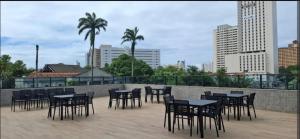 a group of tables and chairs on a patio at Alugo QUARTO em Apartamento -Centro de Recife in Recife