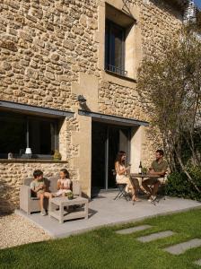 a group of people sitting at a table on a patio at La Grange de Junas in Junas