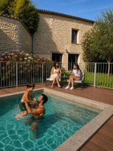 two young boys playing in a swimming pool at La Grange de Junas in Junas