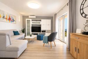 a living room with a couch and a table at Villa Amoena with Pool and Sauna in Brtonigla