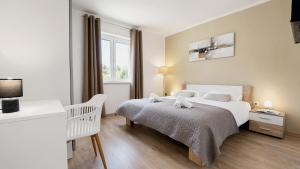a white bedroom with a bed and a window at Villa Amoena with Pool and Sauna in Brtonigla +31 photos