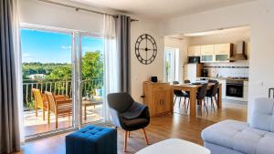 a living room with a table and chairs and a kitchen at Villa Amoena with Pool and Sauna in Brtonigla