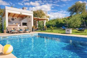 a swimming pool in front of a house at Villa Amoena with Pool and Sauna in Brtonigla