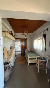 a bedroom with a bed and a chair in a room at The StoneHouse in Keramídhion