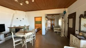 a living room with a table and a dining room at The StoneHouse in Keramídhion