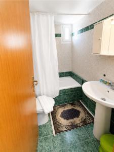 a bathroom with a toilet and a sink at Olga Apartments in Kolónion +9 photos