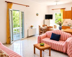 a living room with a couch and a table at Olga Apartments in Kolónion