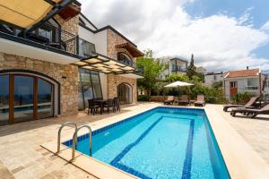 a swimming pool in the backyard of a house at Villa Meltem in Kalkan