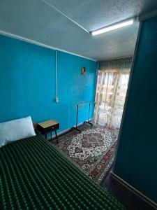 a blue bedroom with a bed and a blue wall at Номера в Фонтанке in Fontanka +7 photos
