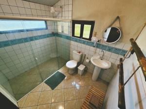 a bathroom with a toilet and a sink at Pousada Ilha do Frade in Fernando de Noronha +52 photos