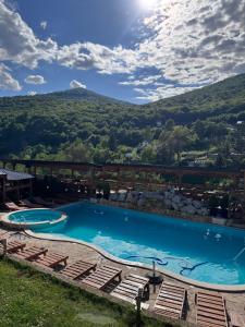 a swimming pool with a mountain in the background at Vikendica Bjelašnica II in Sarajevo