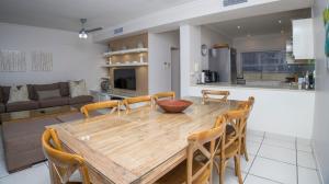 a dining room and kitchen with a wooden table and chairs at D3 Sea Lodge - by Stay in Umhlanga in Durban