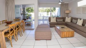 a living room with a couch and a table at D3 Sea Lodge - by Stay in Umhlanga in Durban