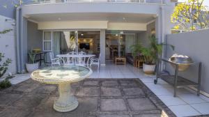 a patio with a table and a dining room at D3 Sea Lodge - by Stay in Umhlanga in Durban