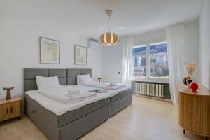 a bedroom with a large bed and a large window at Lugano Lake View Villa with Private Pool in Lugano