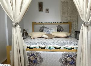 a bedroom with a bed with curtains and a bed sidx sidx sidx at Villa Island Zembra in El Haouaria