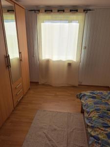 a bedroom with a window and a bed and a door at Bright and spacious home with good in Klepp +2 photos