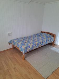 a bed sitting in a corner of a room at Bright and spacious home with good in Klepp