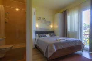 a bedroom with a bed and a bathroom with a tub at Apartments & Rooms Sanja in Rab