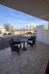 a patio with chairs and a table on a roof at Vila Rubin in Eforie Nord +3 photos