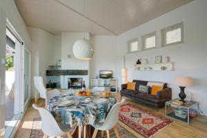 a living room with a table and a couch at La Cà Da Brè - Garden House with Views - Happy Rentals in Lugano +32 photos
