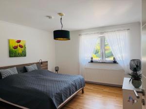 a bedroom with a bed and a window at Ferienwohnung Auszeit Langsur in Langsur