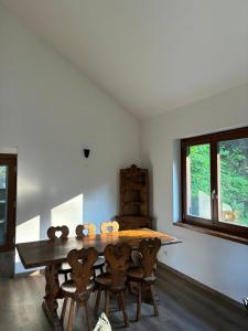 a dining room with a wooden table and chairs at Casa RIGPA in Bellagio