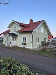 a large white house with a red roof at Kanalhuset in Motala